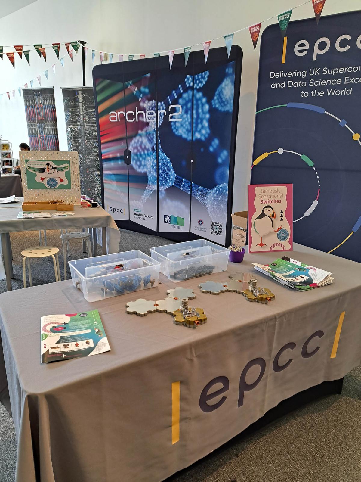 Exhibition stand with displays and "EPCC" tablecloth