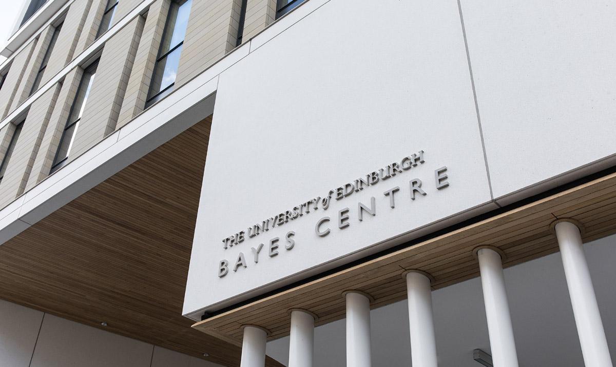 Photo of Bayes Centre: flat white panel with building name, supported by vertical columns.