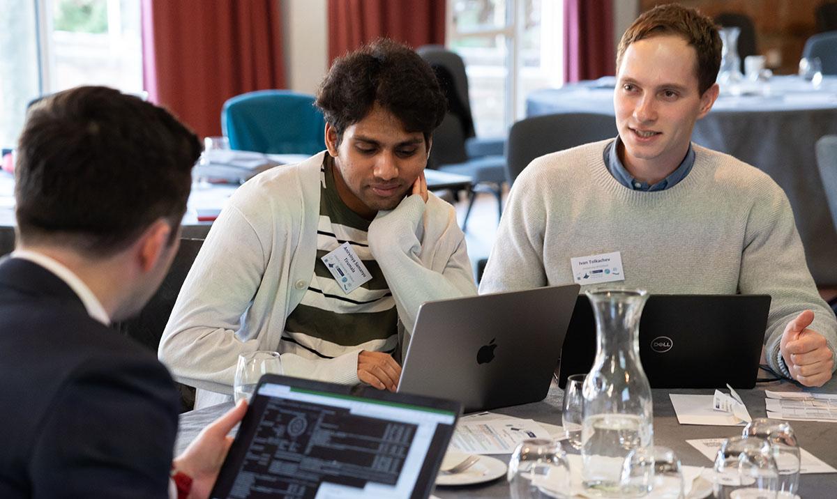 Group of people collaborating with laptops