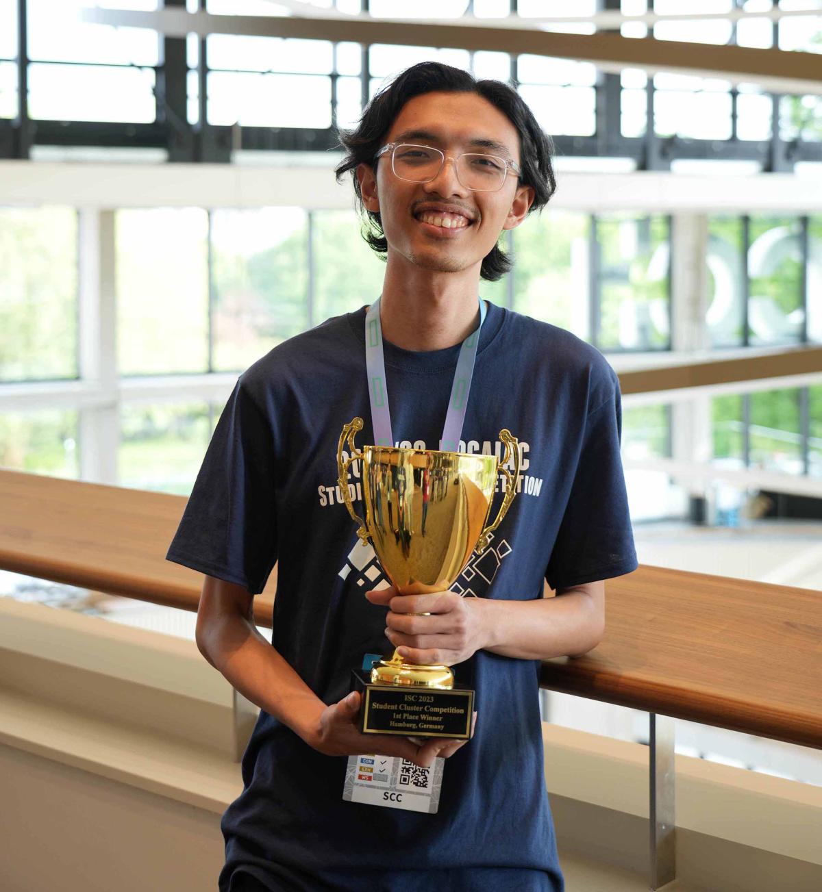 Young man with trophy cup