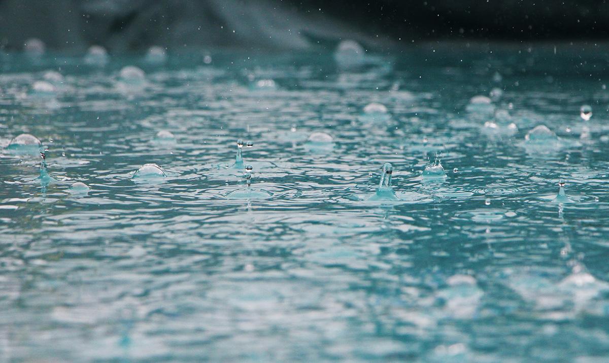 rain falling into water