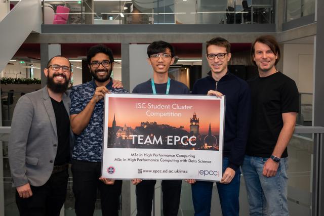 5 young men holding a poster