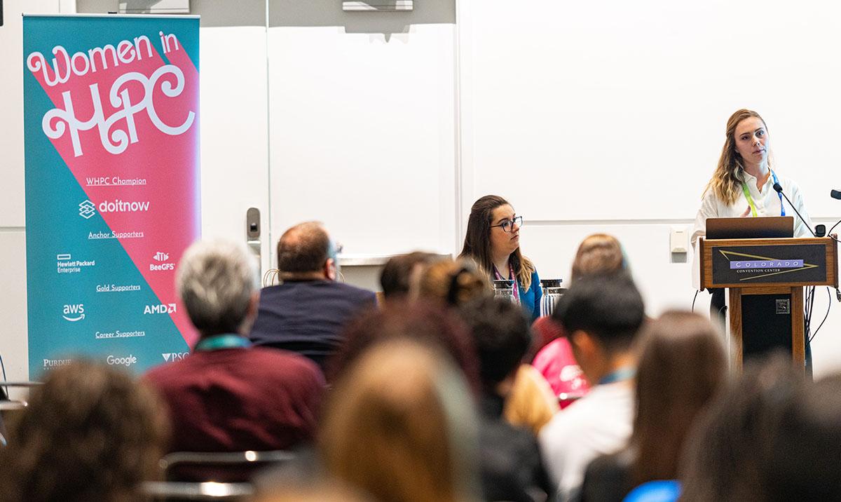 Woman speaking at podium to seated group