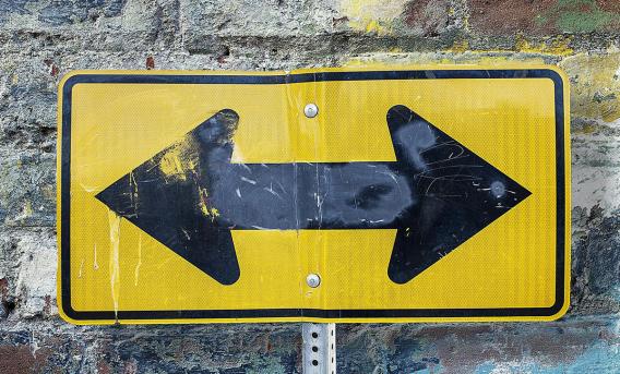 Two-way black arrow on yellow background