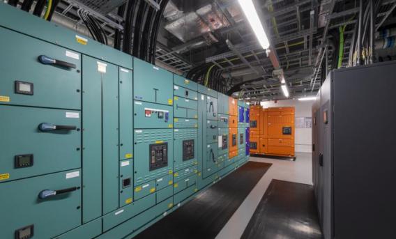 View of large green and also orange control panels in technical facility