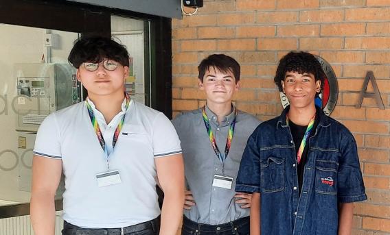 Nuffield school students visiting EPCC's ACF. Image shows 3 older school students standing outside a brick building