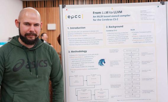PhD student with research poster
