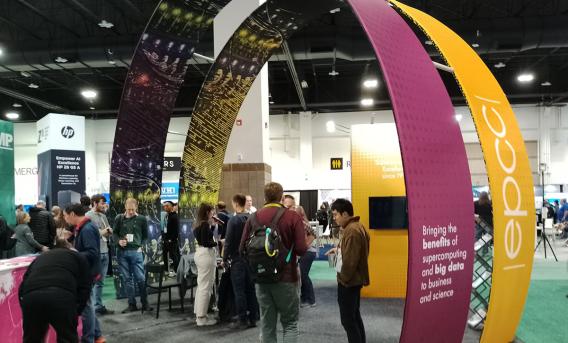 Exhibition stand with 2 large, crossing arches and people standing beneath.