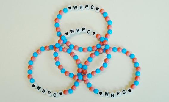 4 beaded bracelets with "WHPC" on each
