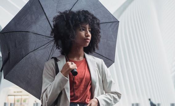 Woman with umbrella. Photo by Roberto Hund via Pexels