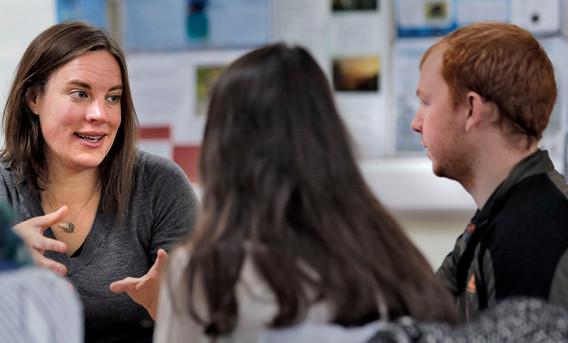 woman talking to 2 others